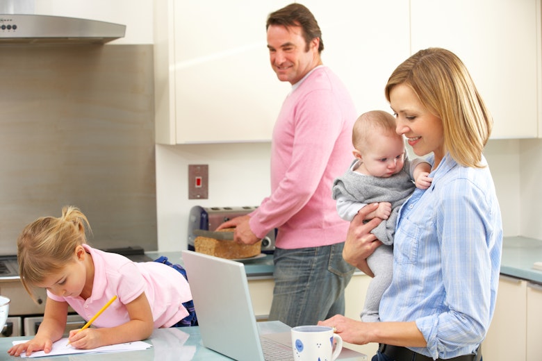Middle Class Family In Kitchen With Laptop